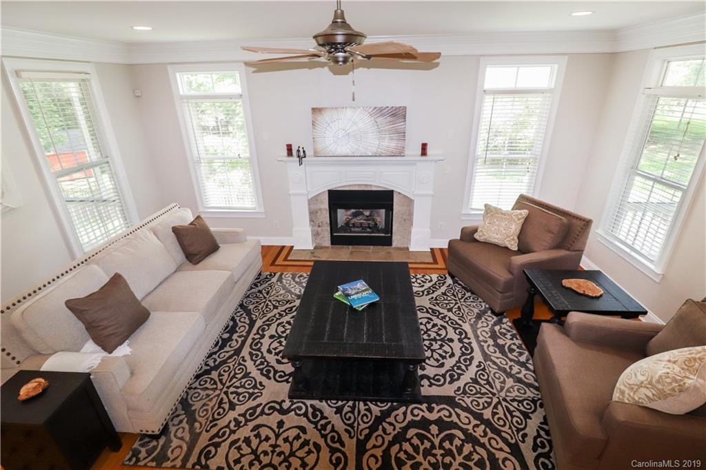 3458 Blue Jay Pass Fort Mill, SC 29708 - Photo 6 of 33 a living room with furniture a window and a fireplace