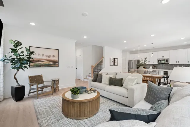 a living room with furniture and a potted plant