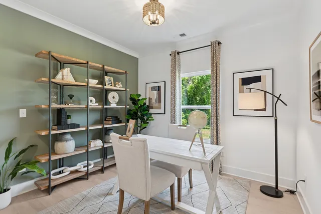 a dining room with furniture and a window