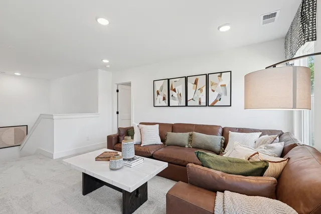 a living room with furniture and a night stand