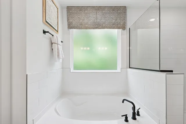 a bathroom with a bathtub and a shower