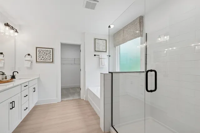 a bathroom with a shower sink and mirror