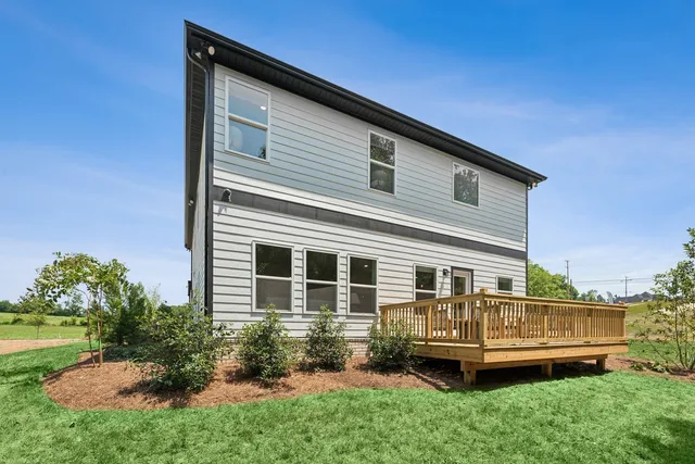a front view of a house with a yard table and chairs