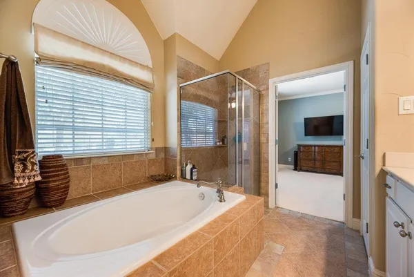 a bathroom with a bathtub and a shower