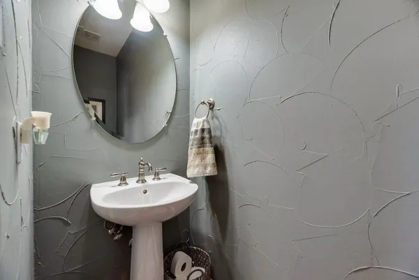 a bathroom with a sink and mirror