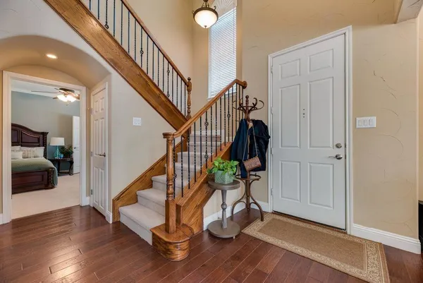 a view of entryway with wooden floor and stairs