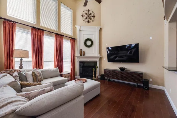 a living room with furniture a flat screen tv and a fireplace