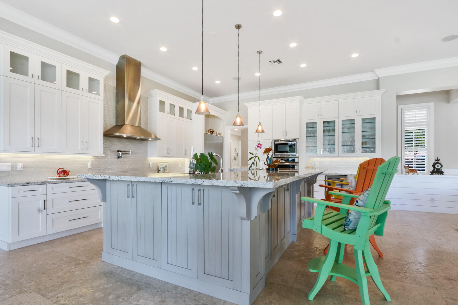 1304 Peninsular Road Jupiter, FL 33469 - Photo 12 of 67 a kitchen with kitchen island cabinets and chairs