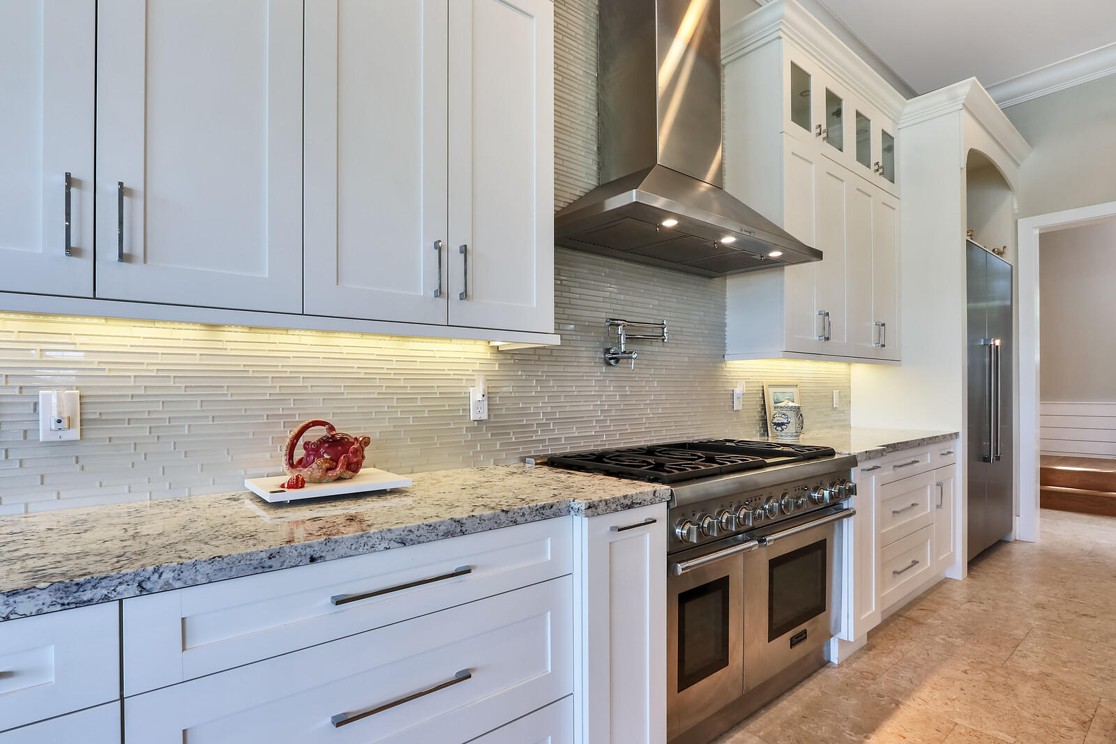 1304 Peninsular Road Jupiter, FL 33469 - Photo 13 of 67 a kitchen with stainless steel appliances granite countertop a stove a sink and a microwave