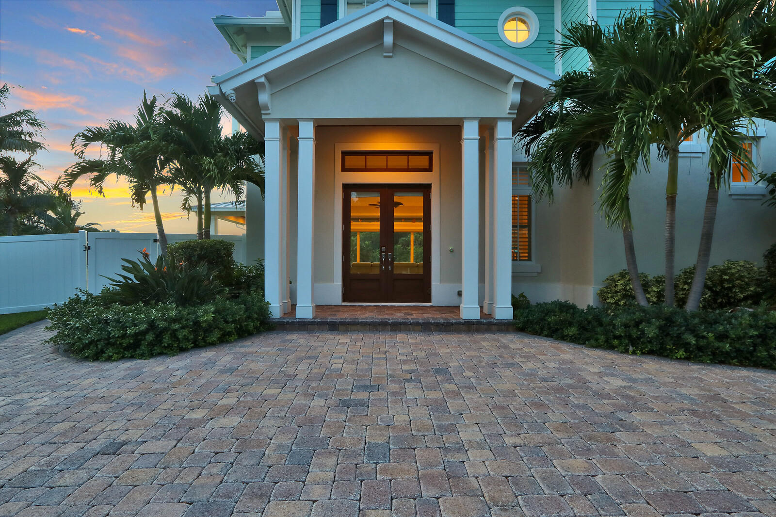 1304 Peninsular Road Jupiter, FL 33469 - Photo 63 of 67 a front view of a house with a yard and garage