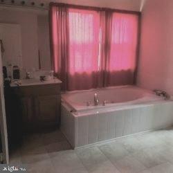 8405 Tee Road Lusby, MD 20657 - Photo 7 of 19 a bathroom with a sink and a bathtub