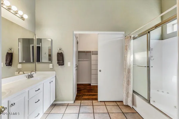 a bathroom with a double vanity sink and a mirror