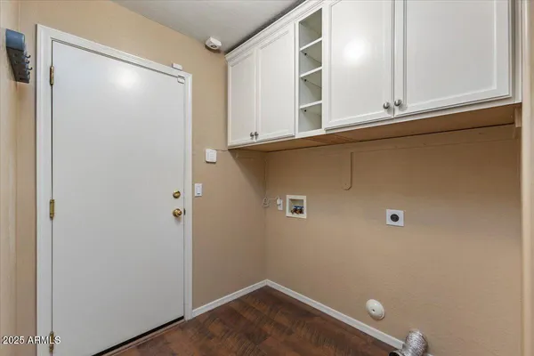 a view of bathroom with a sink mirror and wooden floor