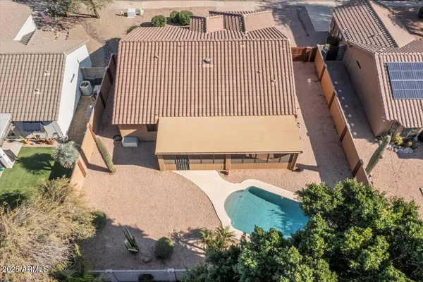 an aerial view of a house with a yard