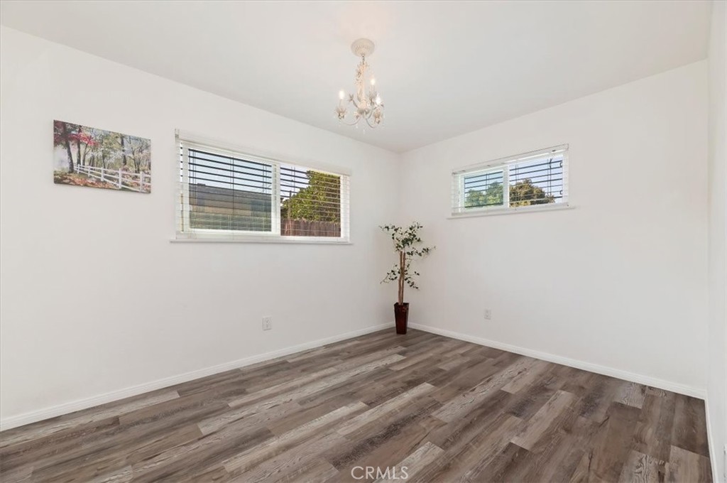 8797 Brunswick Avenue Riverside, CA 92503 - Photo 14 of 23 a view of a room with wooden floor and window
