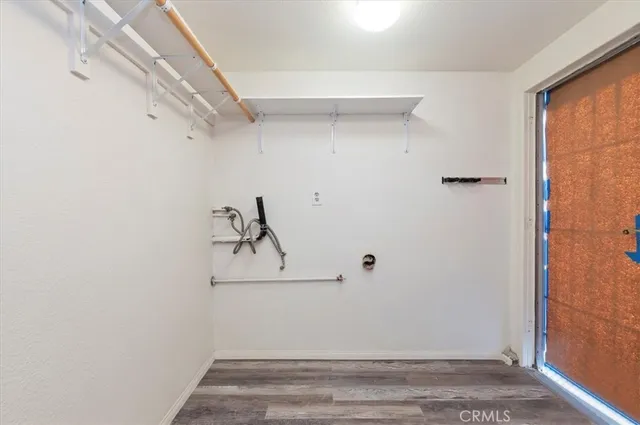 a front view of a house with a yard and potted plants