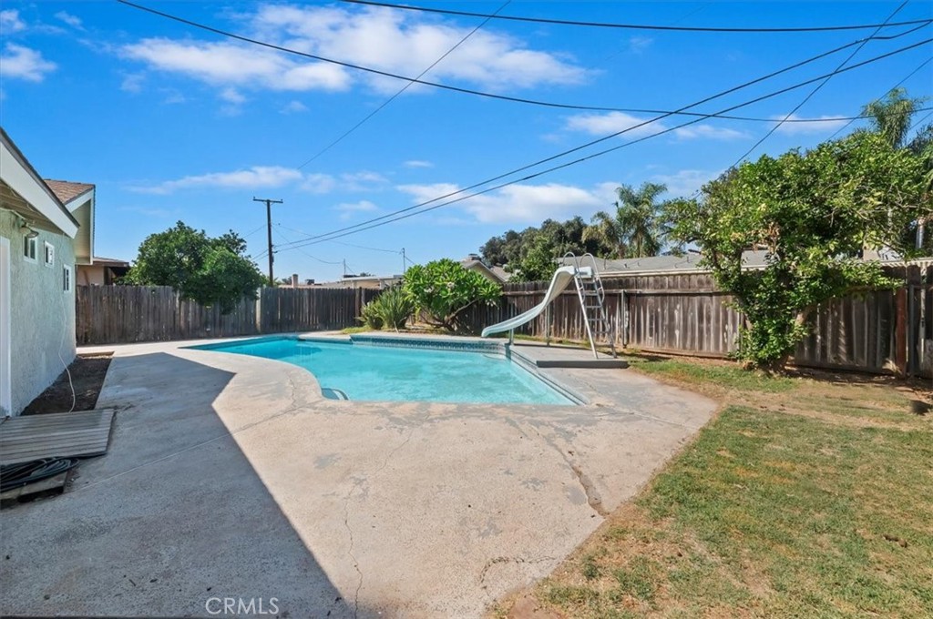 8797 Brunswick Avenue Riverside, CA 92503 - Photo 20 of 23 a view of a backyard with couches plants and large tree