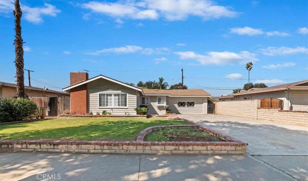 8797 Brunswick Avenue Riverside, CA 92503 - Photo 22 of 23 a front view of a house with a yard