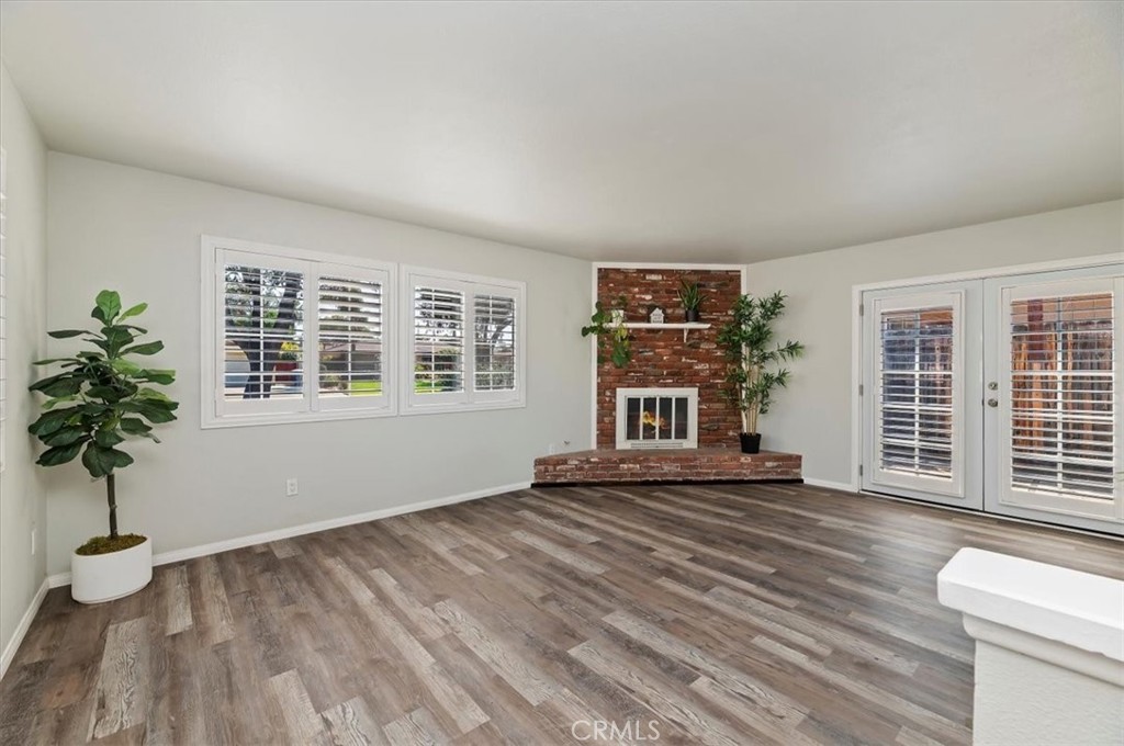 8797 Brunswick Avenue Riverside, CA 92503 - Photo 3 of 23 a view of an empty room with a window and wooden floor