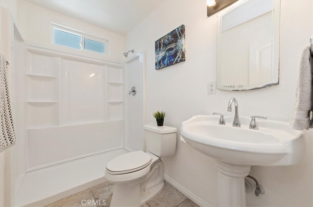 8797 Brunswick Avenue Riverside, CA 92503 - Photo 5 of 23 a bathroom with a sink a toilet and shower