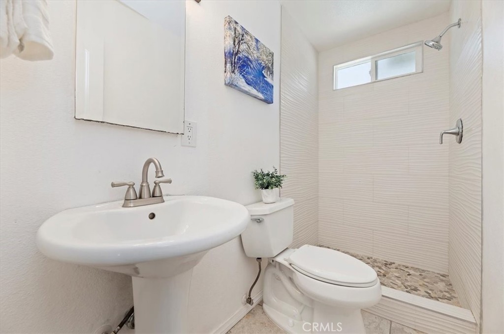8797 Brunswick Avenue Riverside, CA 92503 - Photo 6 of 23 a bathroom with a sink a toilet and shower