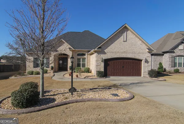 a front view of a house with garden