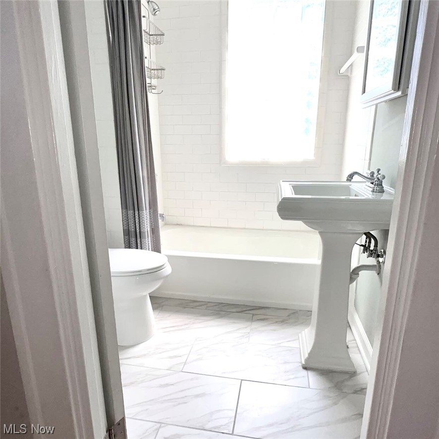 1055 Hillstone Road Cleveland Heights, OH 44121 - Photo 10 of 16 Full bathroom featuring mirror, a healthy amount of sunlight, light tile floors, shower / tub combo, and sink
