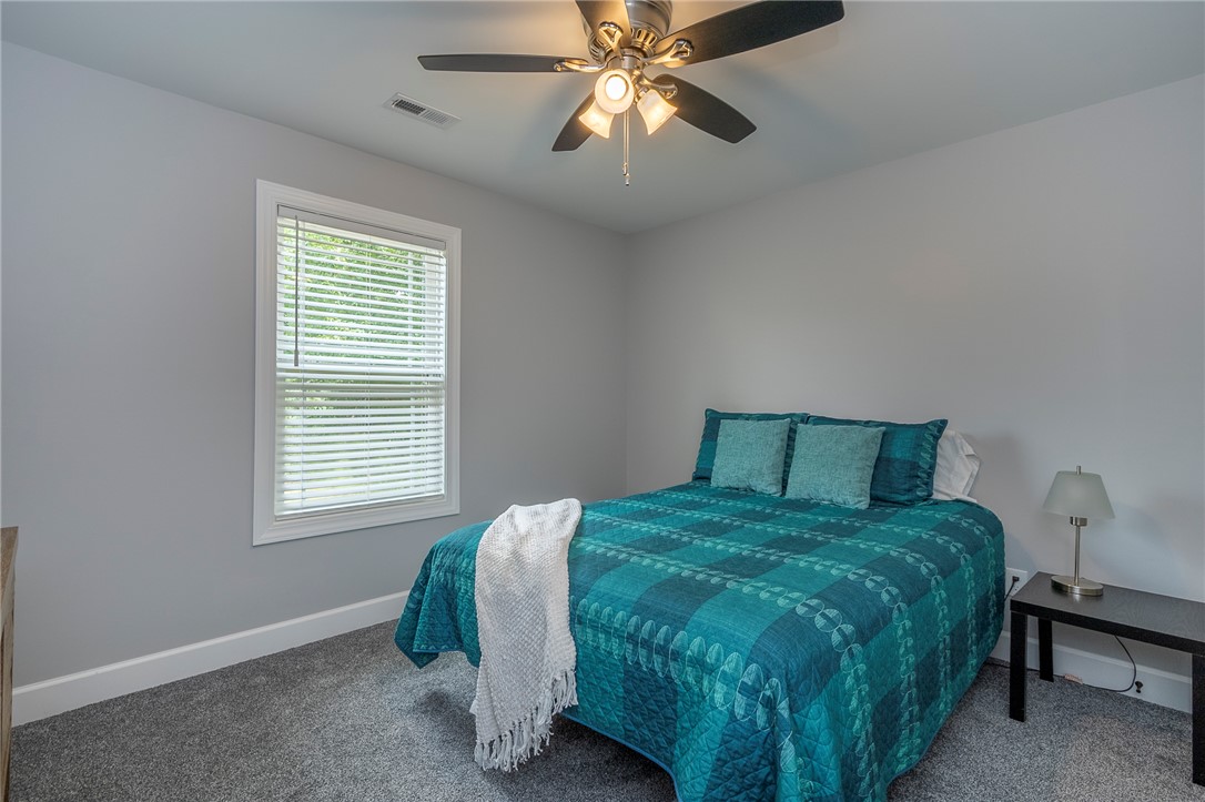 3080 McGee Road Iva, SC 29655 - Photo 25 of 49 Comfortable sleeping quarters featuring soft gray walls and plush carpet for a tranquil retreat.