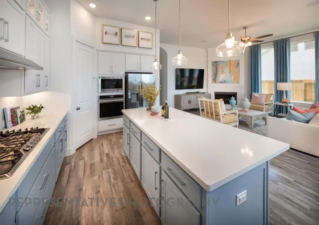 a large kitchen with sink a microwave a stove and refrigerator