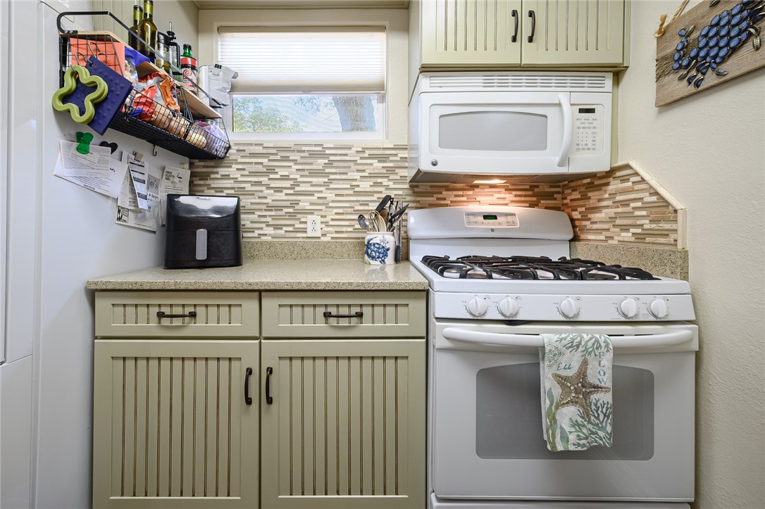 102 South 7th Street Fulton, TX 78358 - Photo 11 of 40 a kitchen with a stove and a microwave