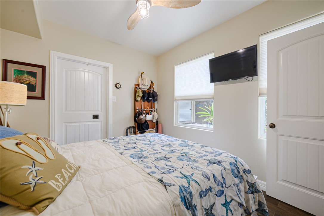 102 South 7th Street Fulton, TX 78358 - Photo 13 of 40 a bedroom with a bed and a flat tv screen on dresser