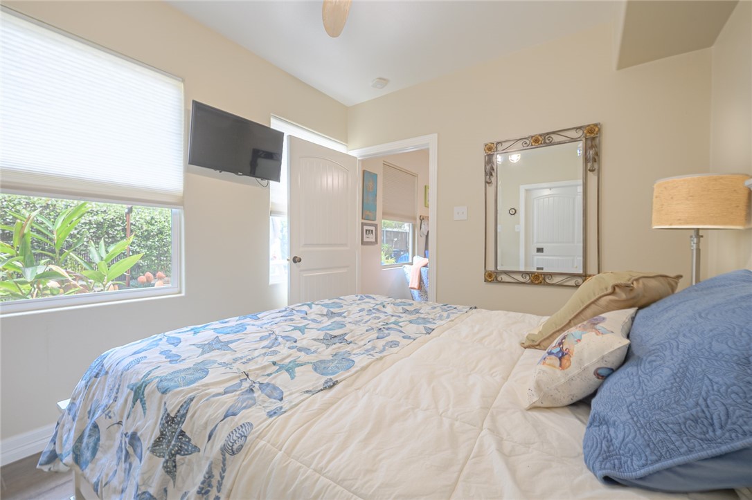 102 South 7th Street Fulton, TX 78358 - Photo 14 of 40 a bedroom with a large bed and a large window