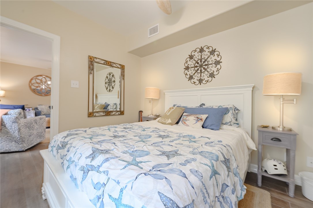 102 South 7th Street Fulton, TX 78358 - Photo 15 of 40 a bedroom with a large bed and a lamp