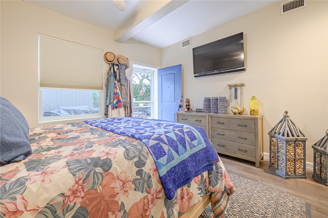 102 South 7th Street Fulton, TX 78358 - Photo 19 of 40 a bedroom with a bed and a flat screen tv