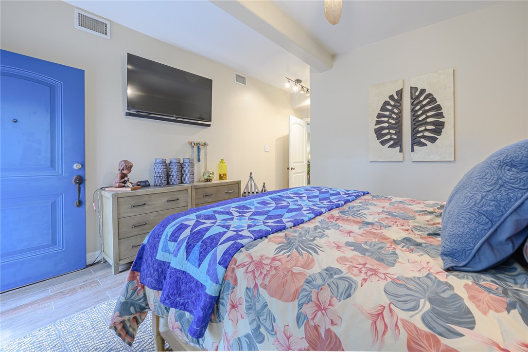 102 South 7th Street Fulton, TX 78358 - Photo 20 of 40 a bedroom with a bed a flat screen tv and a window