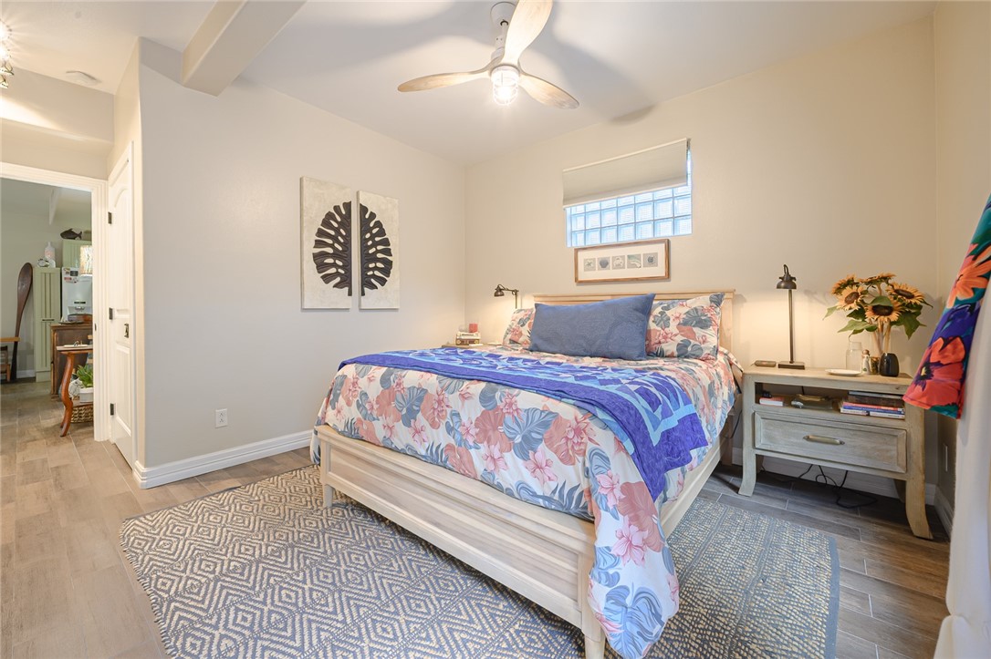 102 South 7th Street Fulton, TX 78358 - Photo 21 of 40 a bedroom with a bed and a chandelier