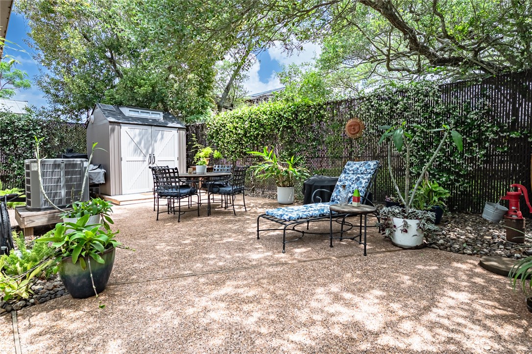 102 South 7th Street Fulton, TX 78358 - Photo 31 of 40 a view of a patio with table and chairs potted plants and large tree