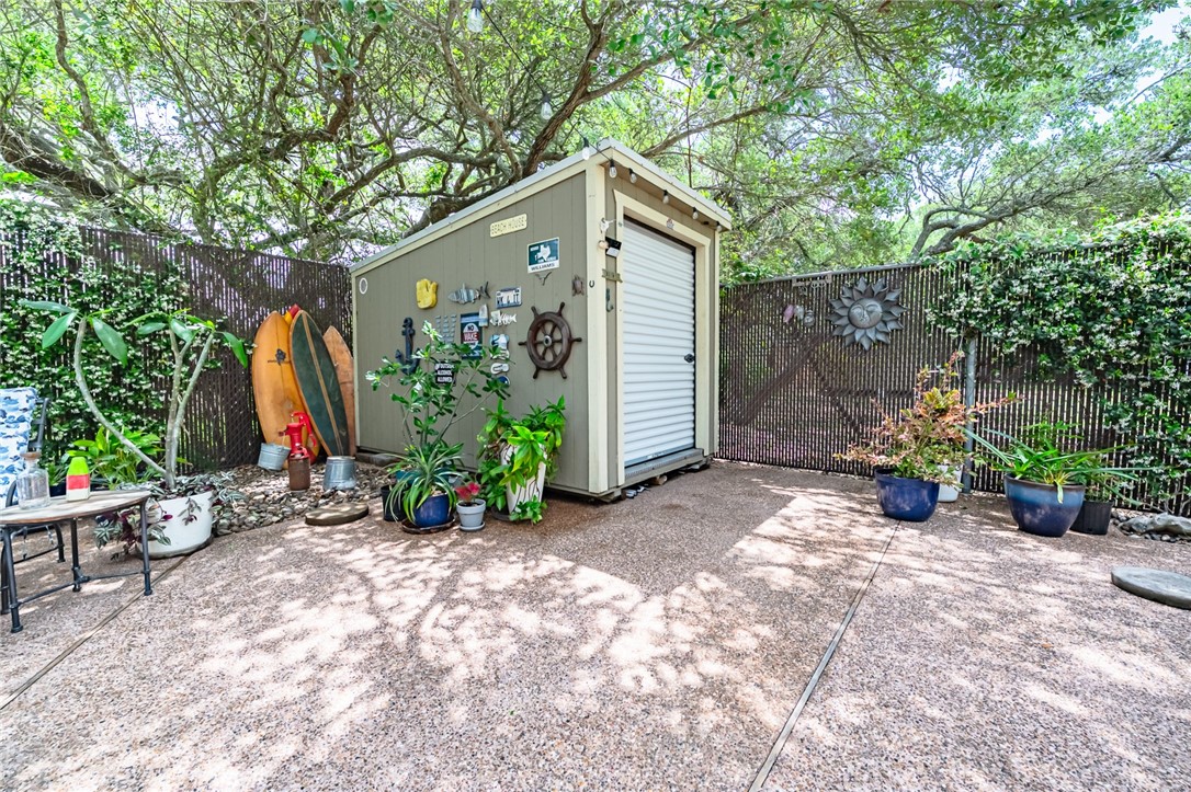 102 South 7th Street Fulton, TX 78358 - Photo 32 of 40 a view of a house with potted plants and a large tree