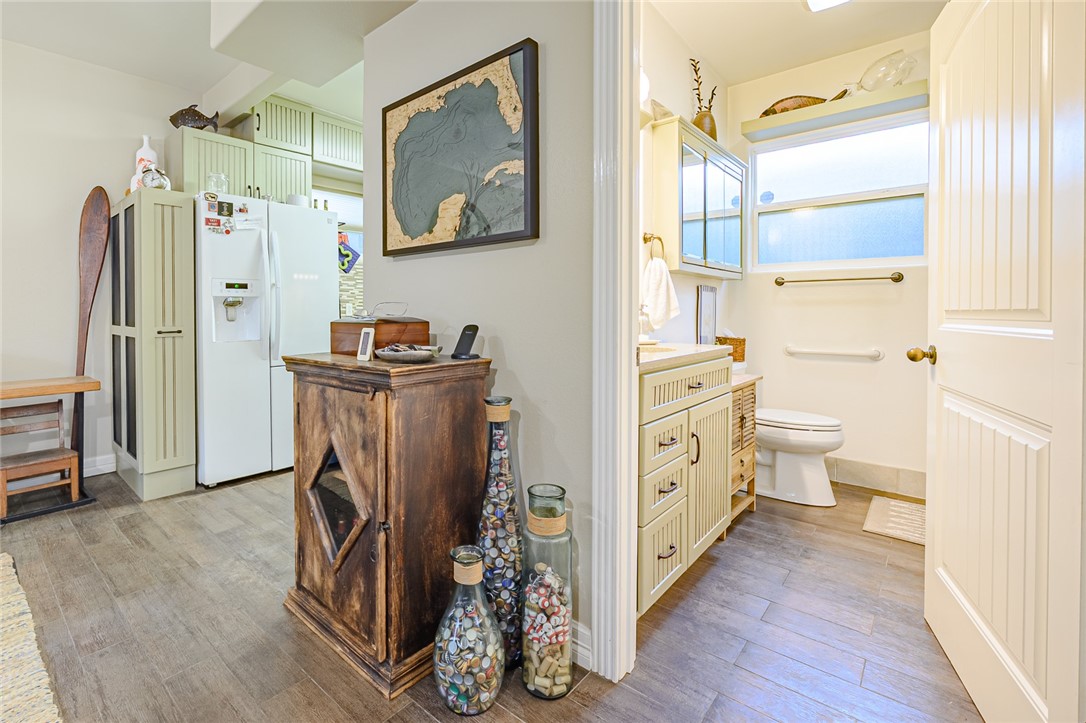 102 South 7th Street Fulton, TX 78358 - Photo 8 of 40 a view of a kitchen with refrigerator and wooden floor