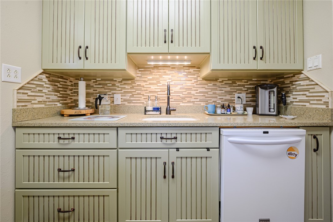 102 South 7th Street Fulton, TX 78358 - Photo 10 of 40 a kitchen with stainless steel appliances granite countertop a sink and cabinets