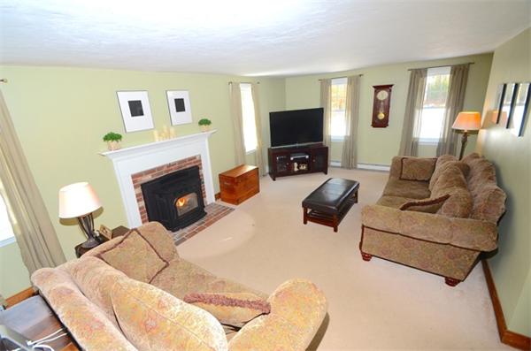 5 Old Farm Lane Rochester, MA 02770 - Photo 4 of 10 a living room with furniture a flat screen tv and a fireplace