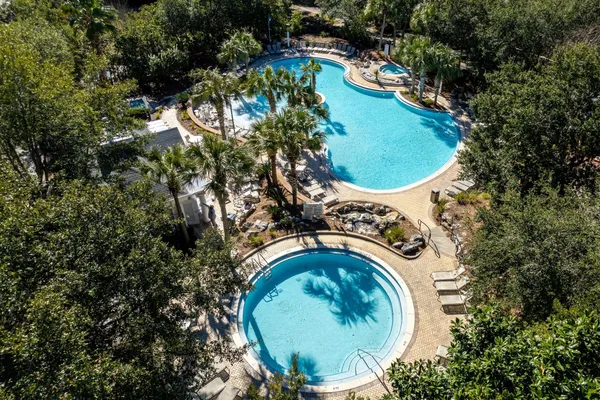 a view of a swimming pool in he middle of the green field