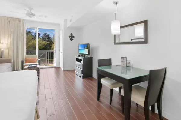 a view of a dining room with furniture window and wooden floor
