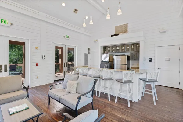 a dining hall with stainless steel appliances granite countertop a sink a stove and a refrigerator
