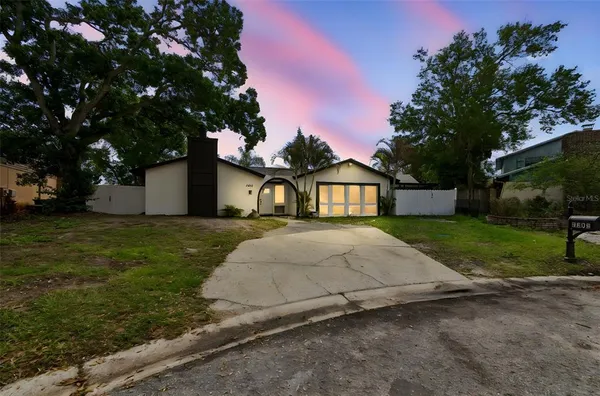 a view of a house with a yard and garage