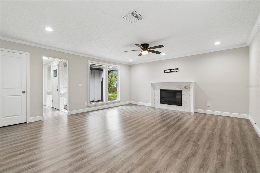 7403 Spring Court Tampa, FL 33634 - Photo 12 of 100 a view of an empty room with a fireplace and a window