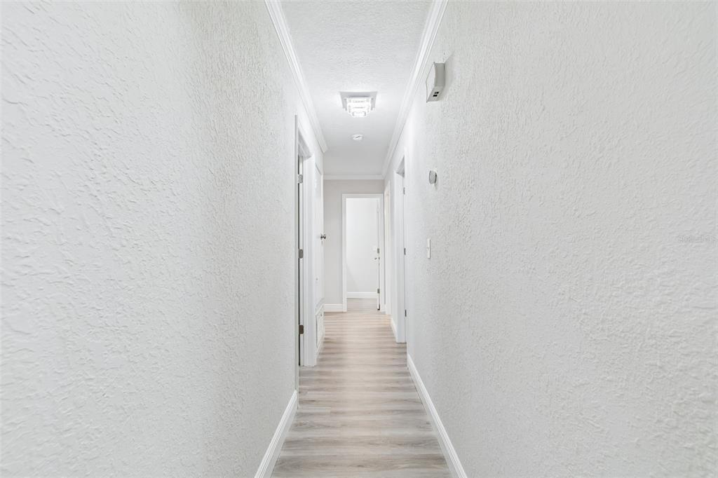 7403 Spring Court Tampa, FL 33634 - Photo 16 of 100 a view of a hallway with wooden floor and staircase