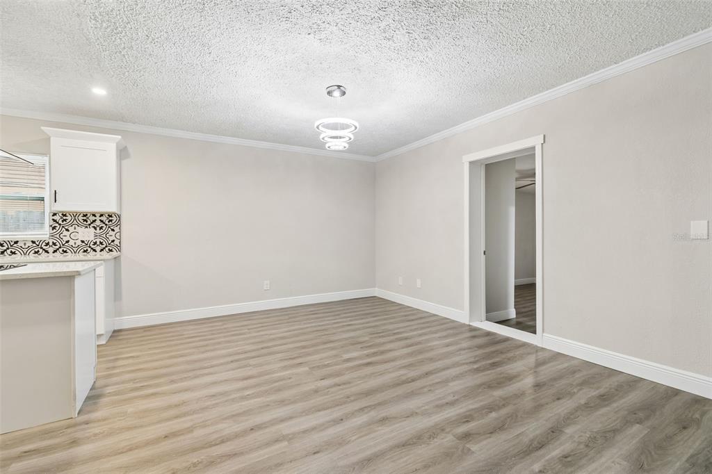 7403 Spring Court Tampa, FL 33634 - Photo 18 of 100 wooden floor in an empty room with a window
