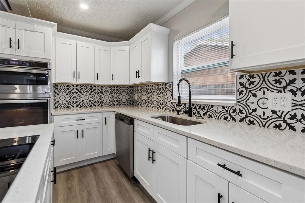 7403 Spring Court Tampa, FL 33634 - Photo 28 of 100 a kitchen with stainless steel appliances white cabinets and a sink