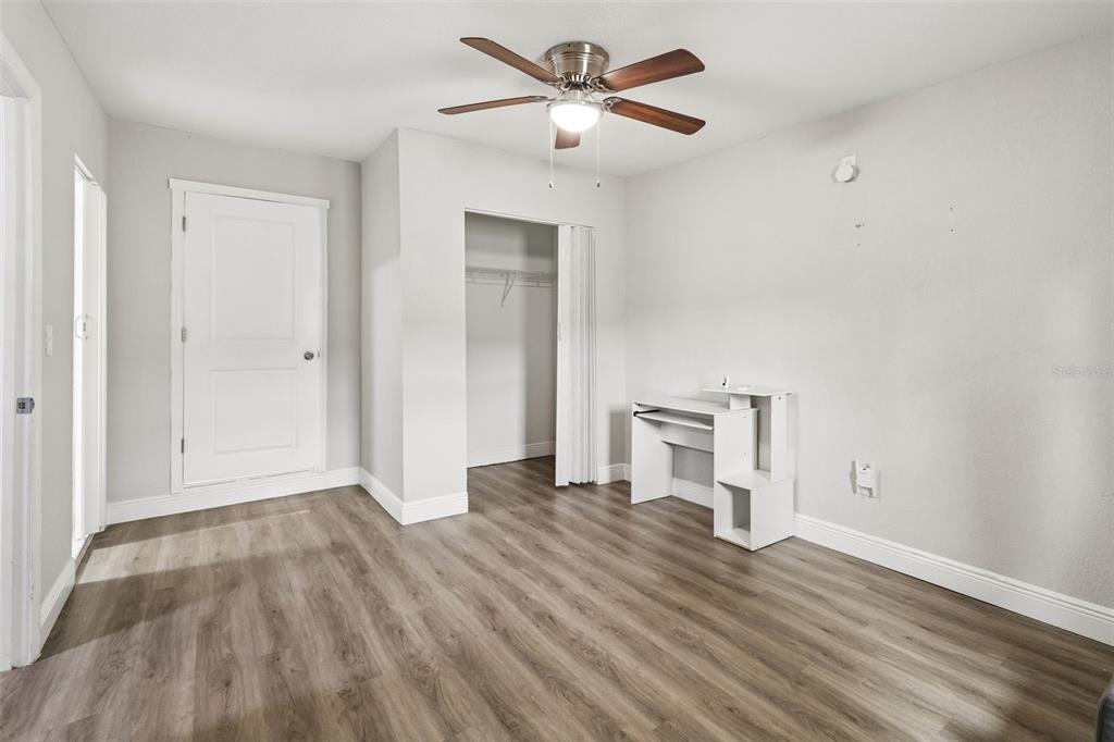 7403 Spring Court Tampa, FL 33634 - Photo 36 of 100 a view of empty room with wooden floor and fan